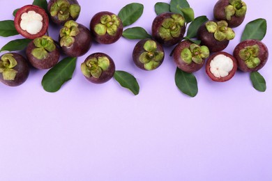 Fresh ripe mangosteen fruits with green leaves on light violet background, flat lay. Space for text