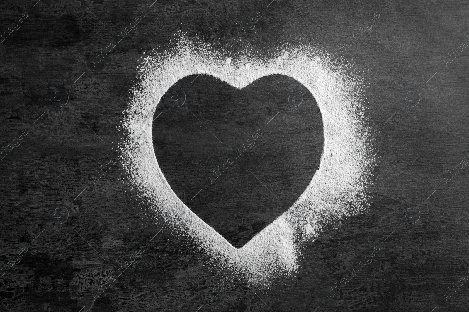 Photo of Heart-shaped frame made of flour on gray background, top view