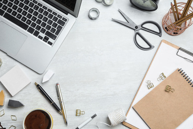 Photo of Flat lay composition with laptop and stationery on white table, space for text. Designer's workplace