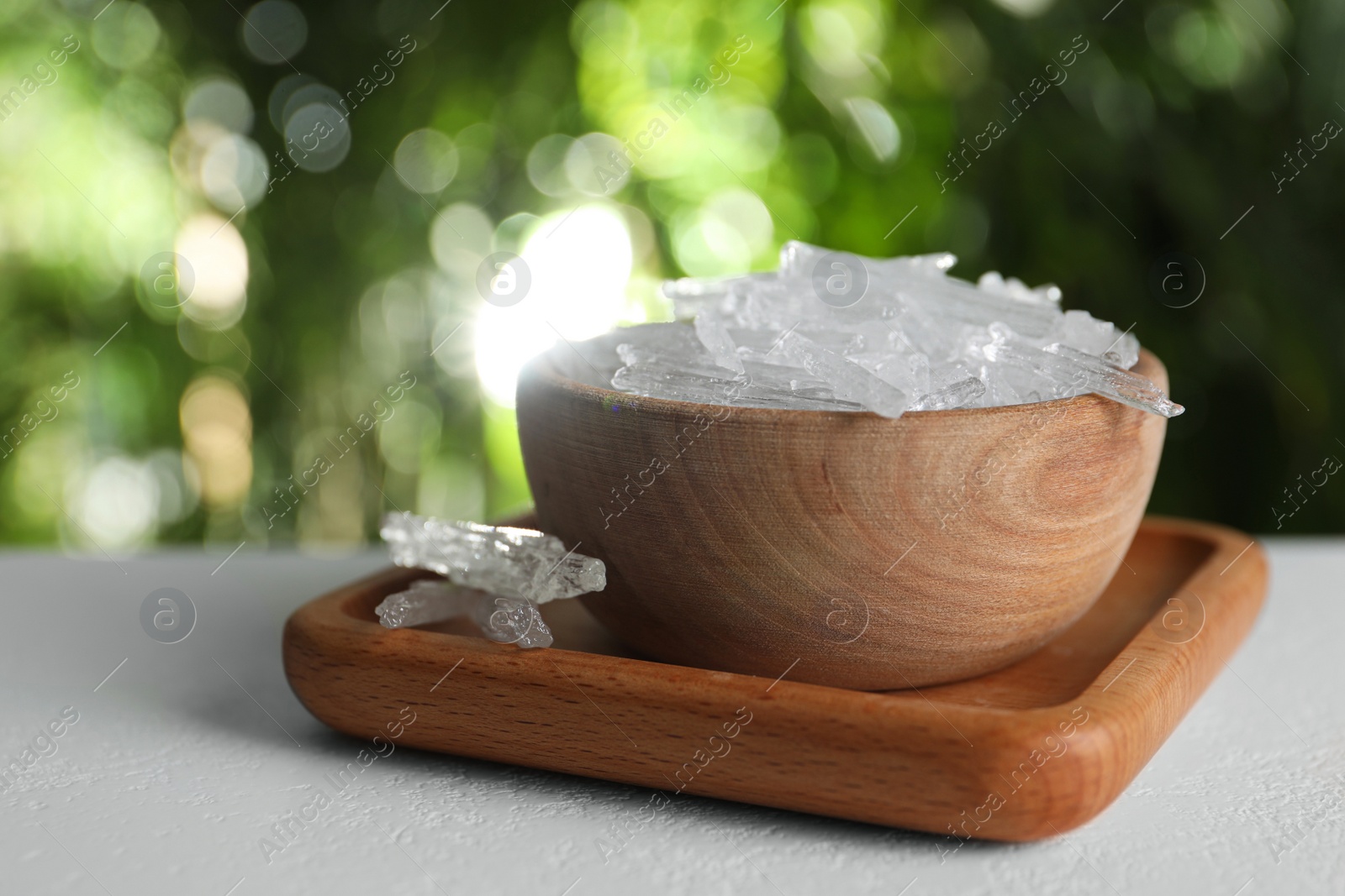 Photo of Menthol crystals on white table against blurred background