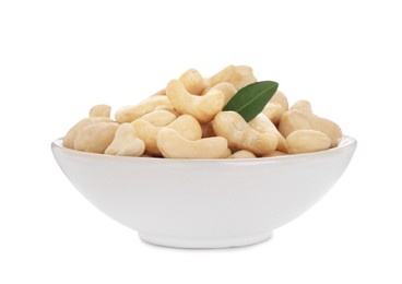 Photo of Bowl of tasty organic cashew nuts and green leaf isolated on white