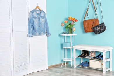 Photo of Storage bench with different female shoes indoors