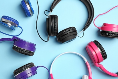Photo of Stylish headphones on color background, flat lay