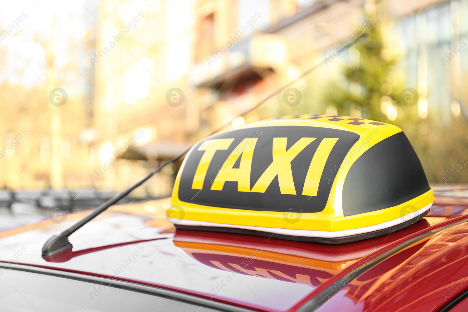 Photo of Roof light with word TAXI on car outdoors