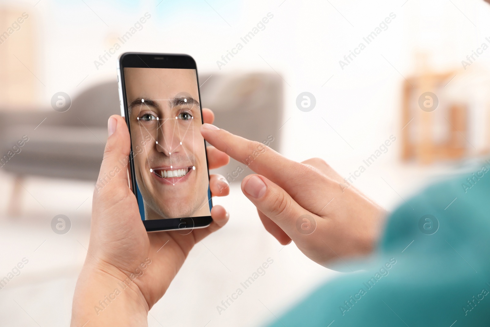 Image of Man using smartphone with facial recognition system indoors, closeup. Biometric verification