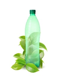Image of Bottle made of biodegradable plastic and green leaves on white background