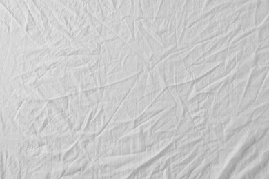 Crumpled white fabric as background, top view