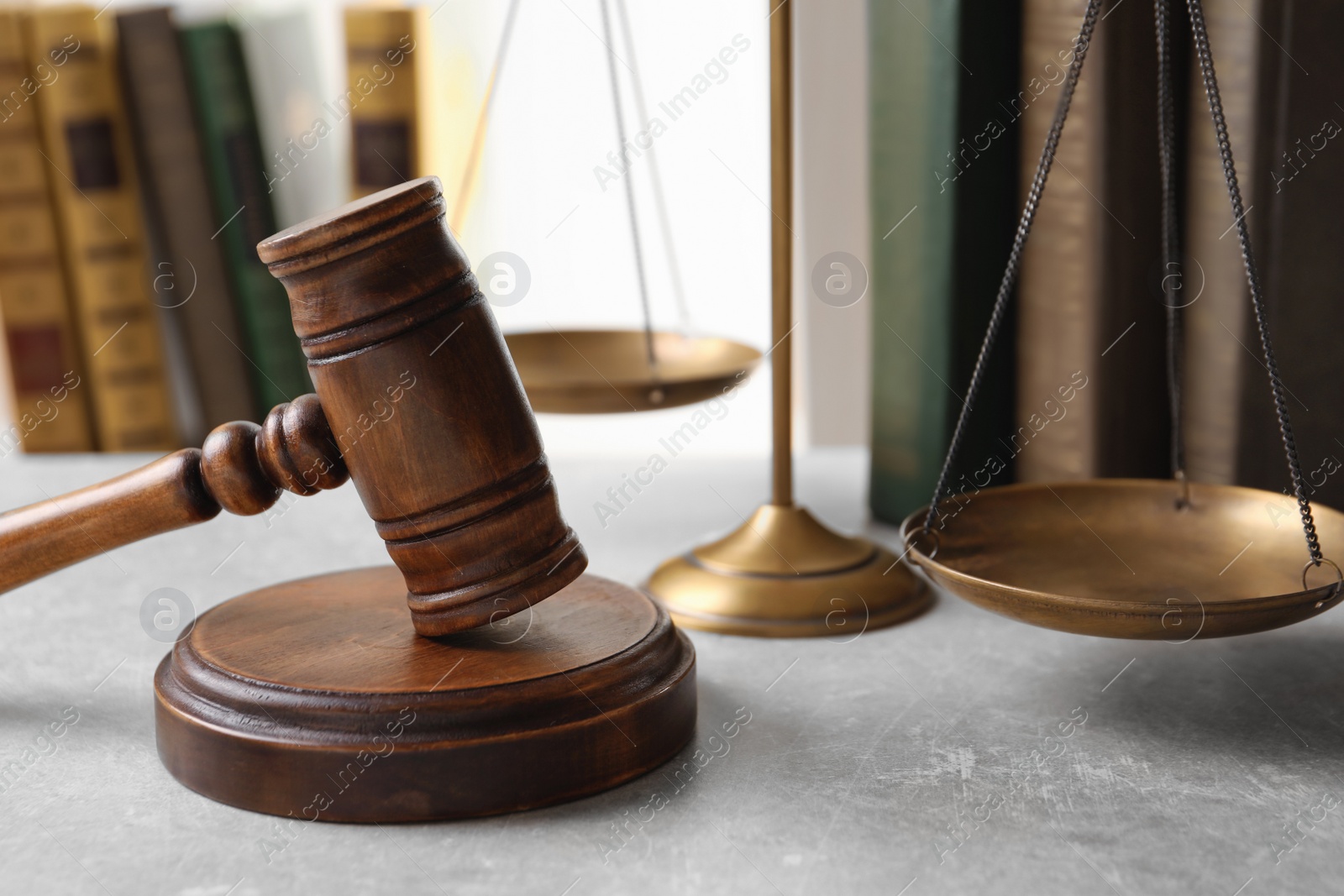 Photo of Wooden gavel, scales of justice and books on table. Law concept