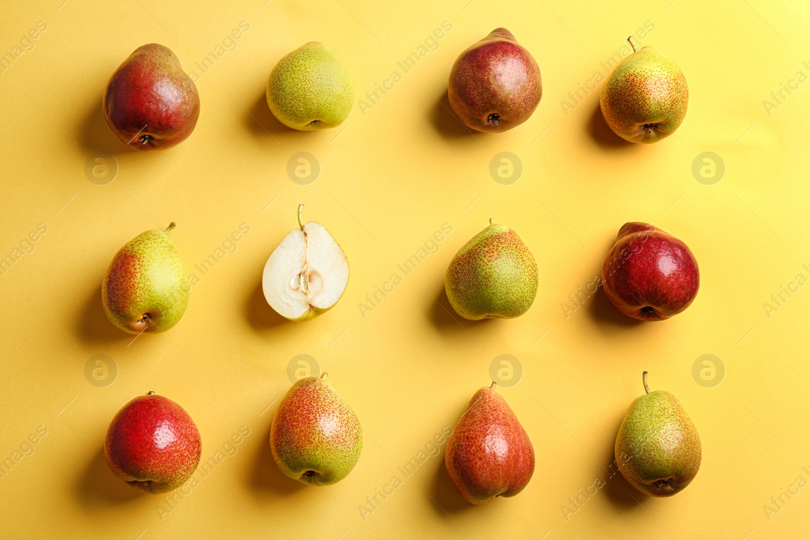 Photo of Ripe juicy pears on yellow background, flat lay