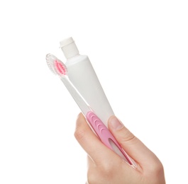 Woman holding toothbrush and paste against white background. Dental care