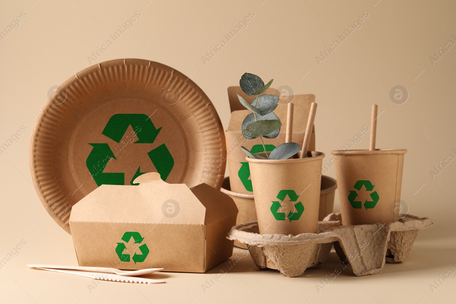 Image of Set of eco friendly food packaging with recycling symbols on beige background