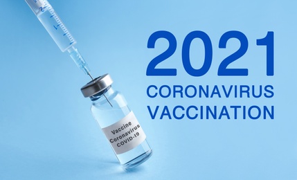Vial with coronavirus vaccine on light blue background 