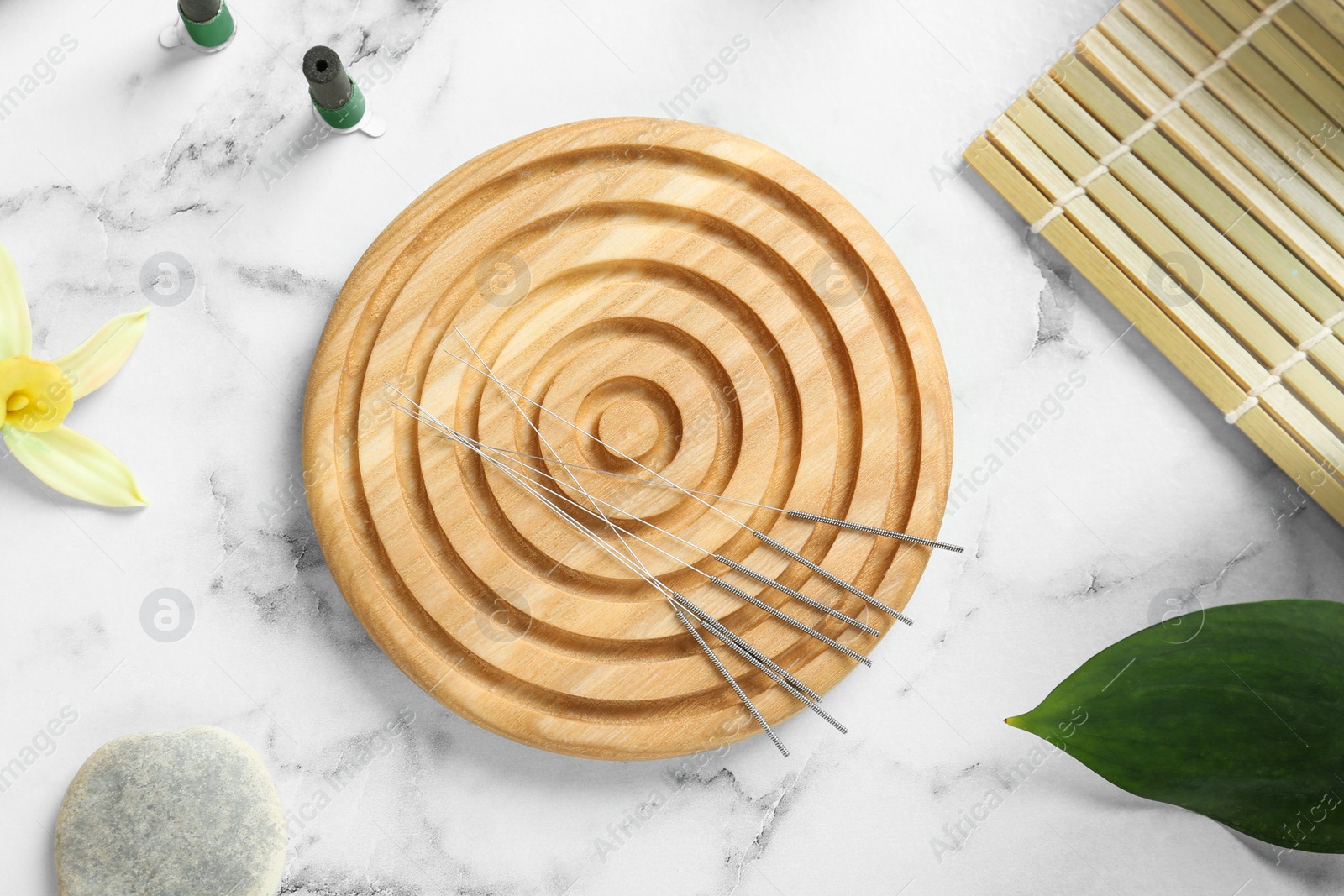 Photo of Flat lay composition with acupuncture needles on white marble table