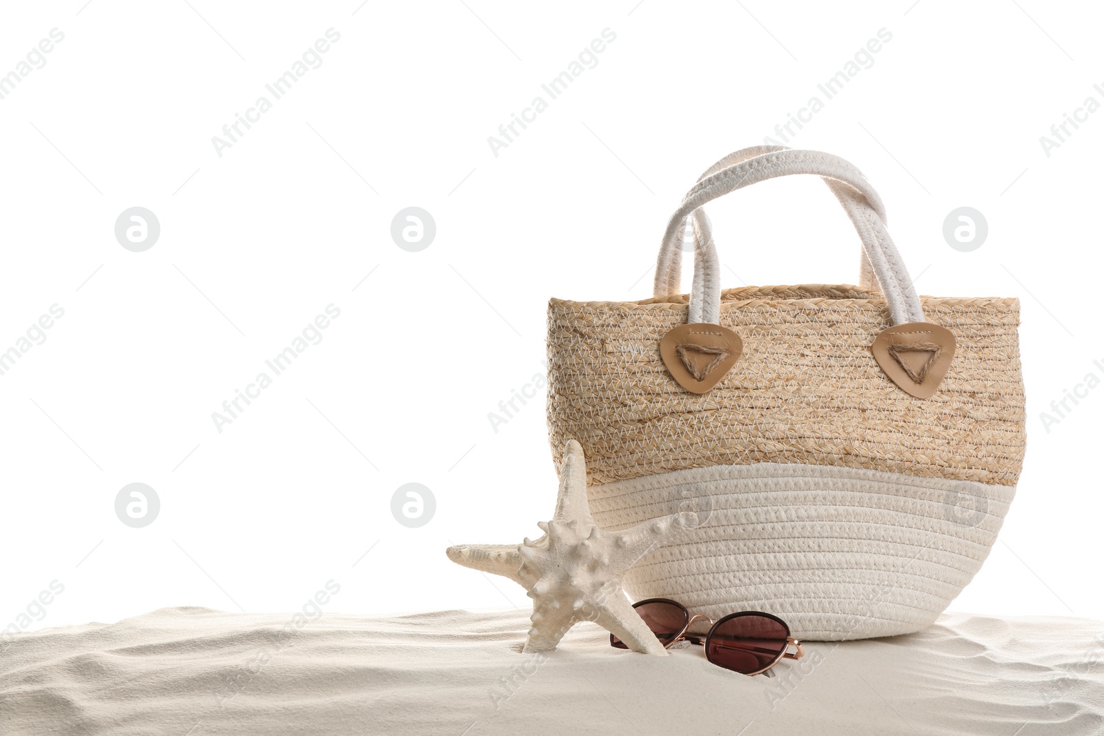 Photo of Stylish bag, sunglasses and starfish on sand against white background. Beach accessories