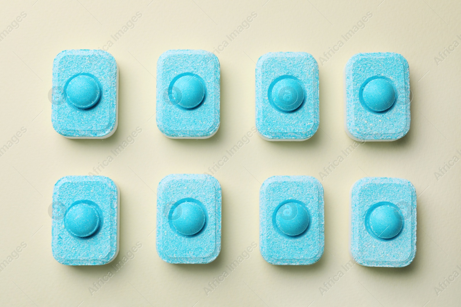 Photo of Water softener tablets on beige background, flat lay