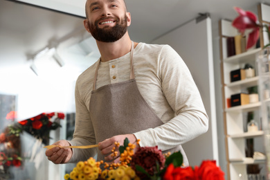 Photo of Professional male florist in apron at workplace