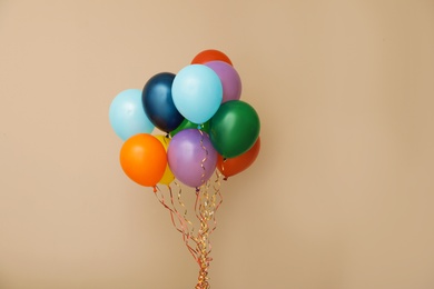 Bunch of bright balloons on color background, space for text. Celebration time