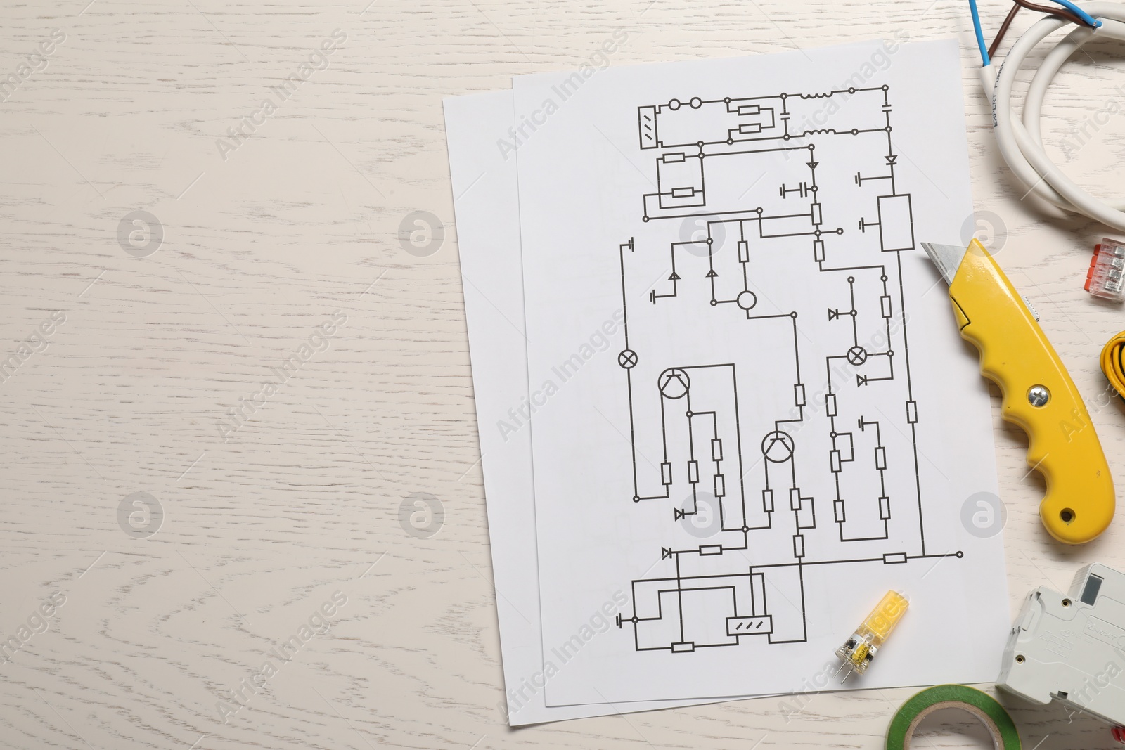 Photo of Flat lay composition with wiring diagrams on white wooden table, space for text