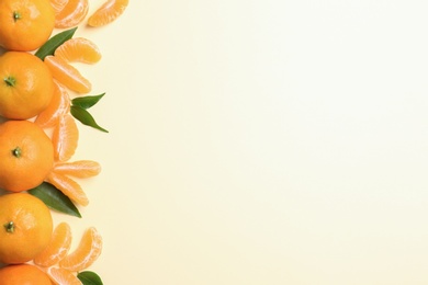 Photo of Composition with tangerines and leaves on color background, flat lay. Space for text