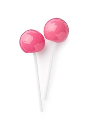 Photo of Two sweet pink lollipops isolated on white, top view