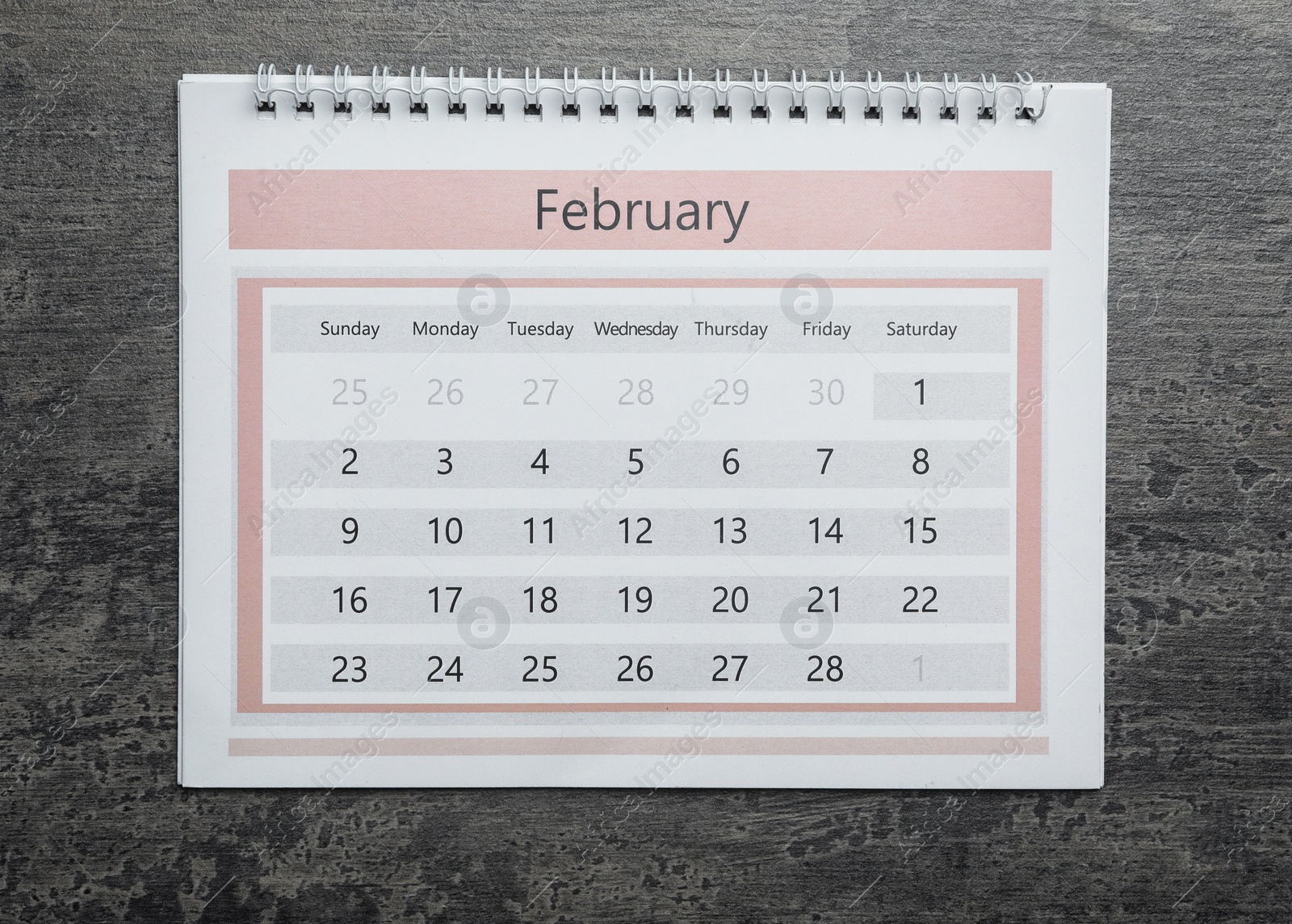 Photo of February calendar on grey stone background, top view