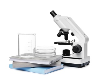 Microscope, books and medical students stuff isolated on white