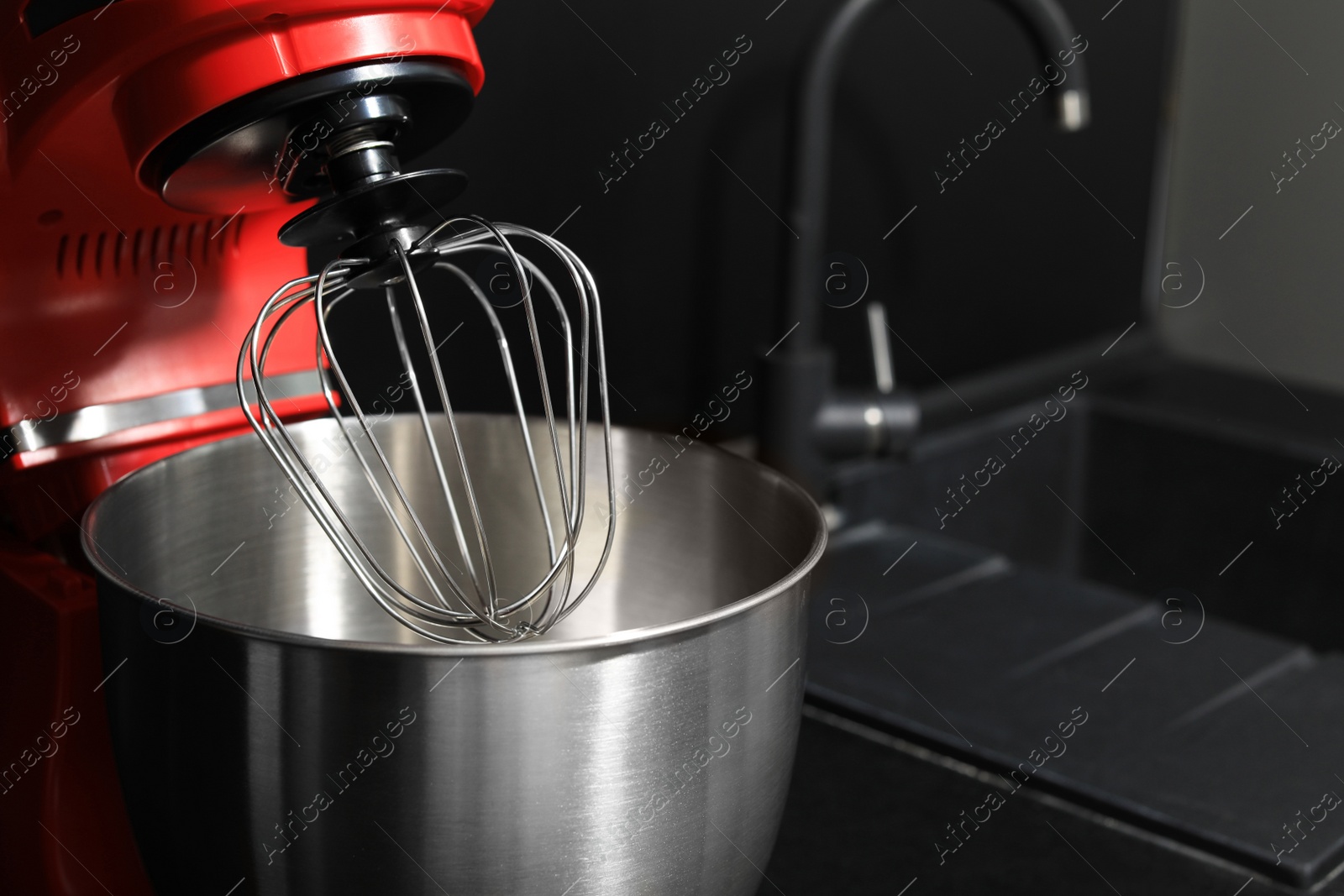 Photo of Modern stand mixer on countertop in kitchen, closeup. Space for text