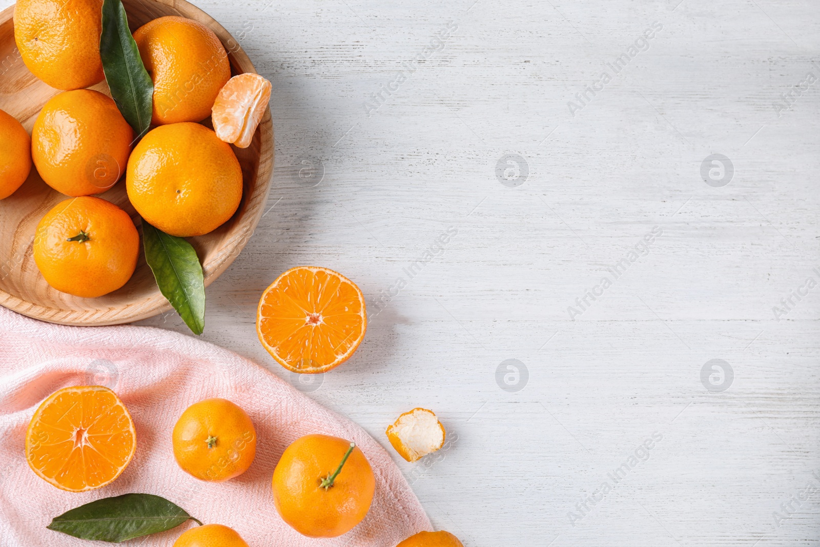 Photo of Fresh ripe tangerines on white wooden table, flat lay. Space for text