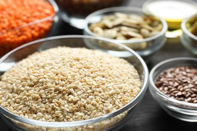 Photo of Sesame seeds in bowl on table, closeup. Healthy fats