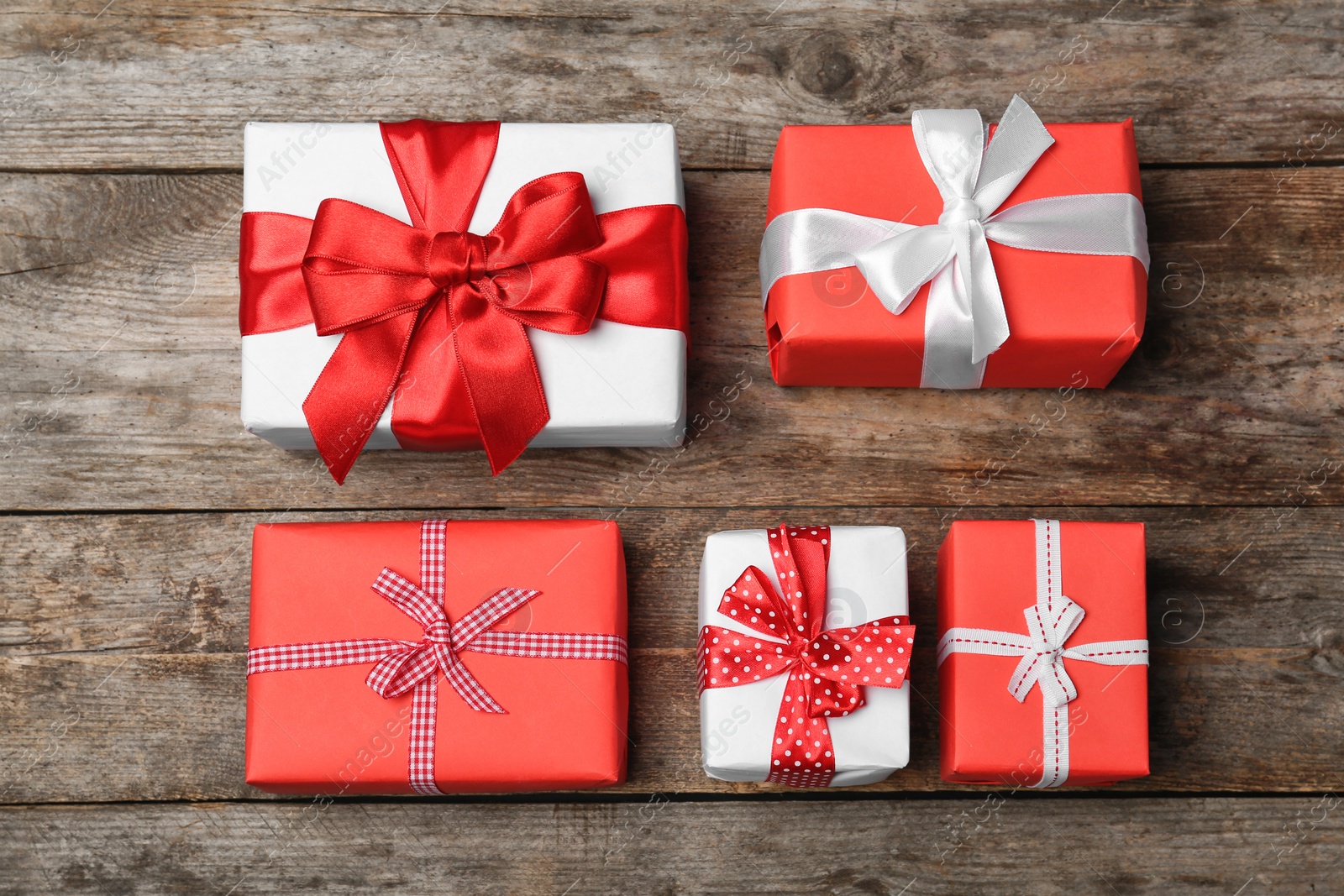 Photo of Flat lay composition with beautiful gift boxes on wooden background