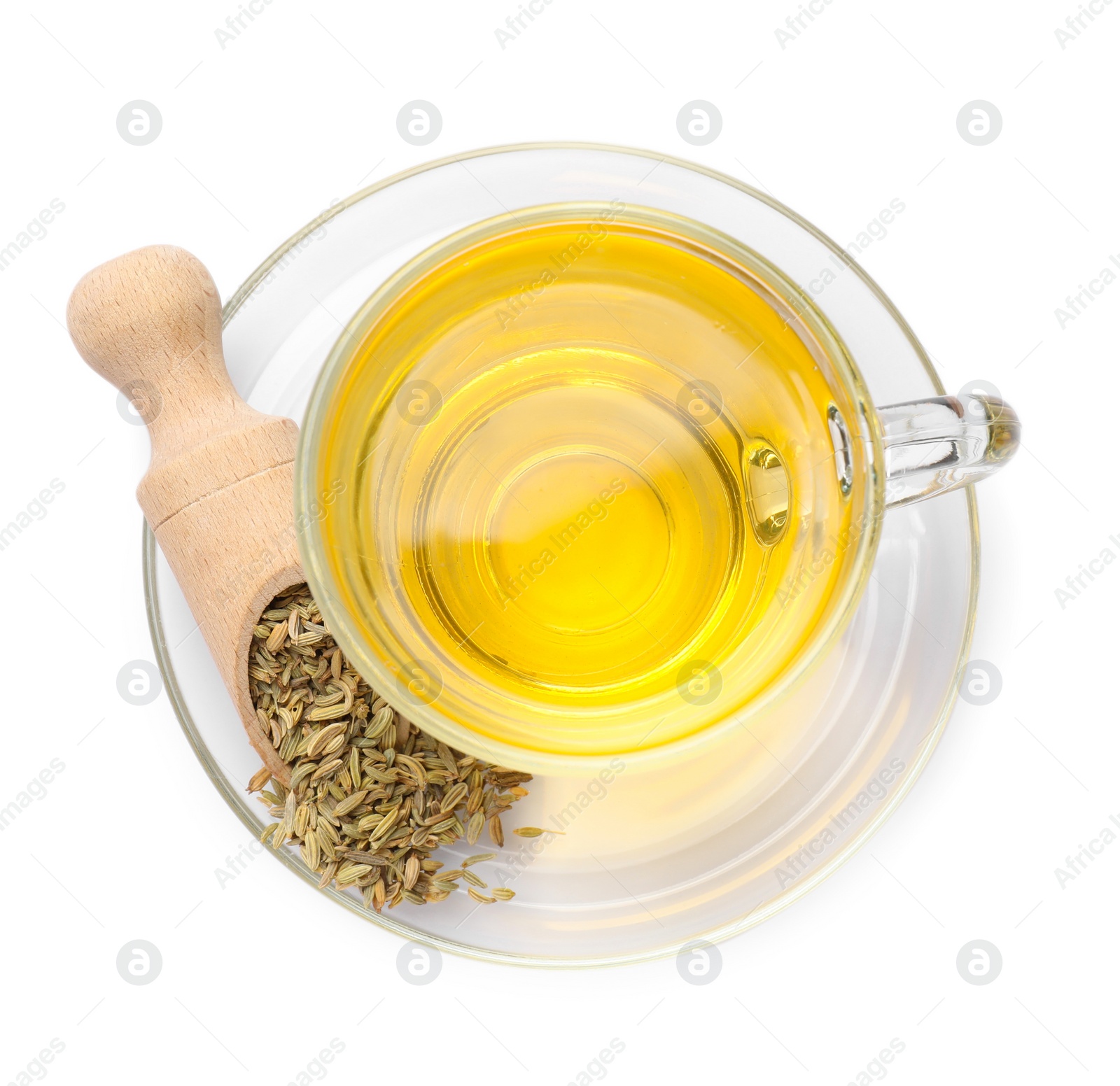 Photo of Aromatic fennel tea in cup, seeds and scoop isolated on white, top view