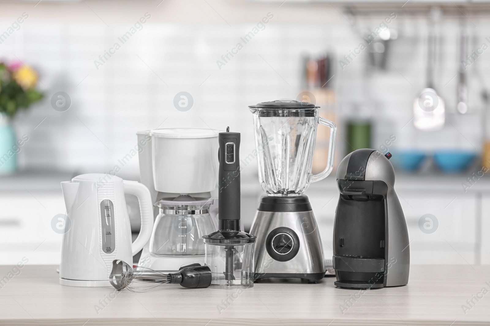 Photo of Different modern kitchen appliances on table indoors. Interior element