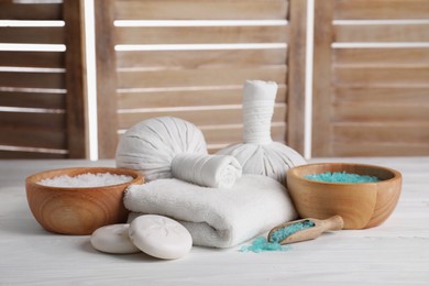 Spa composition with skin care products on white wooden table