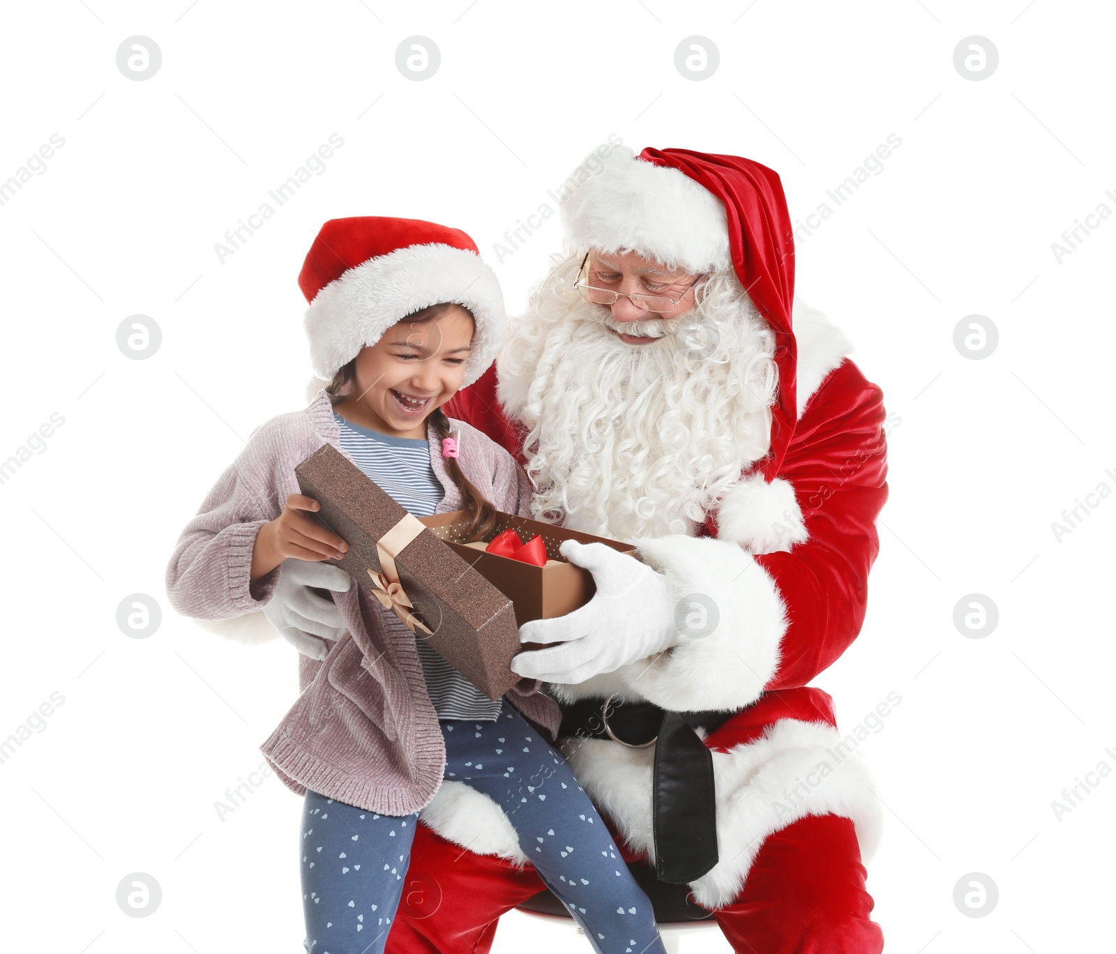 Photo of Little girl receiving gift from authentic Santa Claus on white background