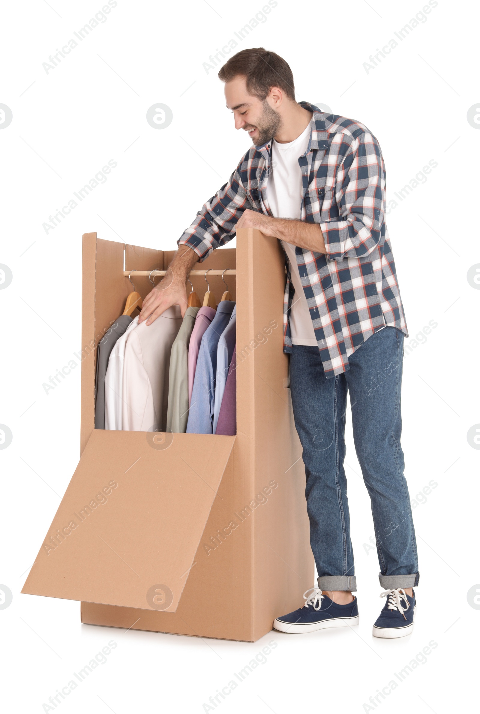 Photo of Young man near wardrobe box on white background