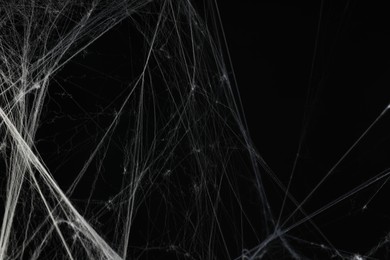 Photo of Creepy white spider web on black background