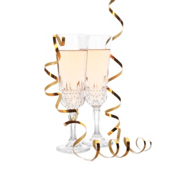 Glasses of rose champagne and streamers on white background