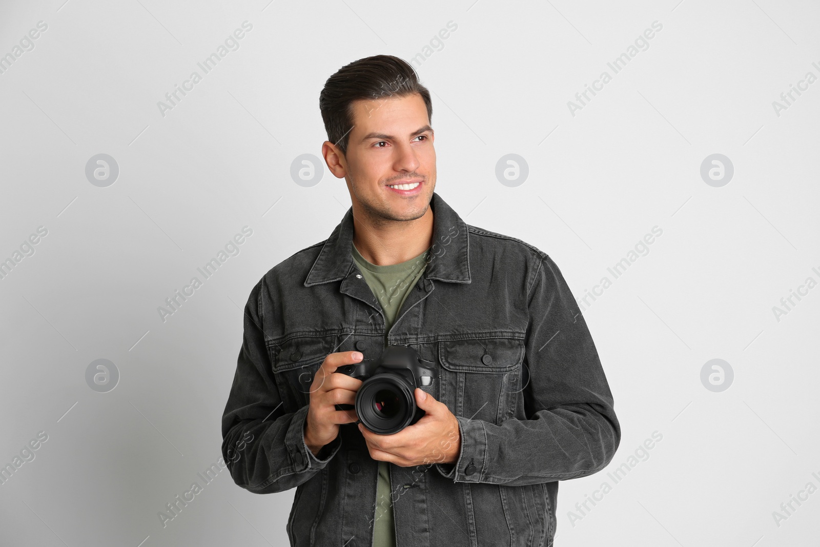 Photo of Professional photographer working on white background in studio