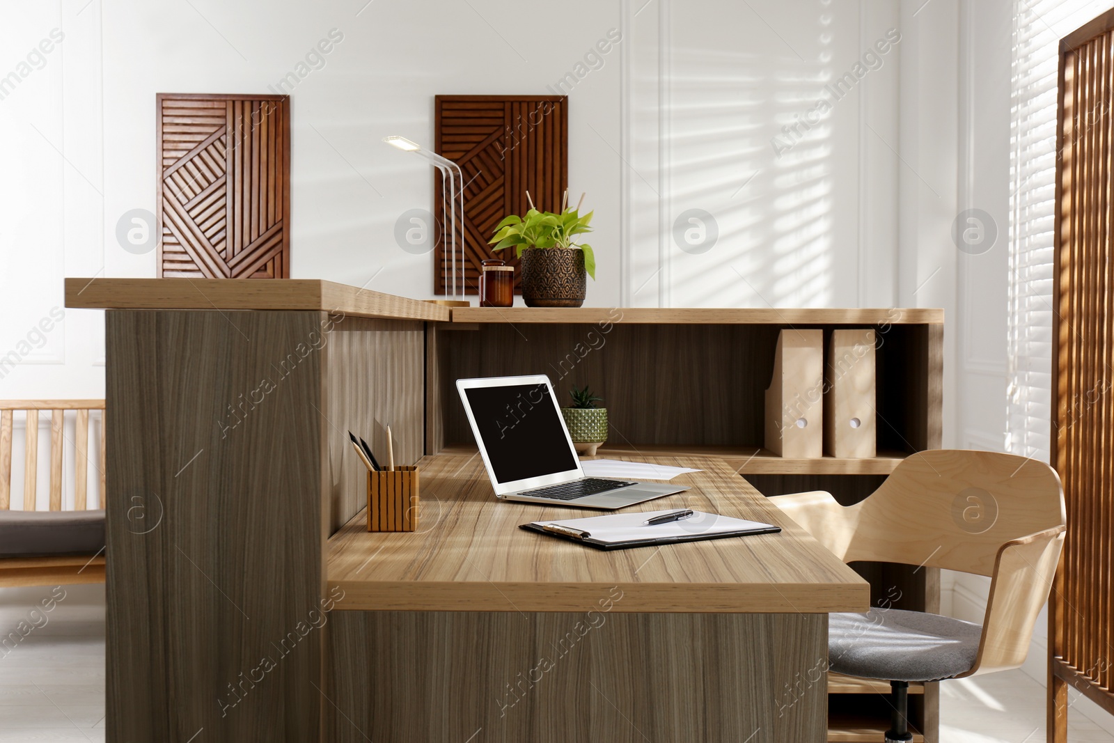 Photo of Receptionist's workplace with laptop in hotel. Interior design