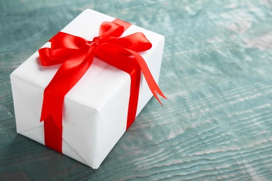 Photo of Elegant gift box with bow on wooden background