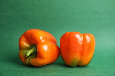 Raw ripe paprika peppers on color background