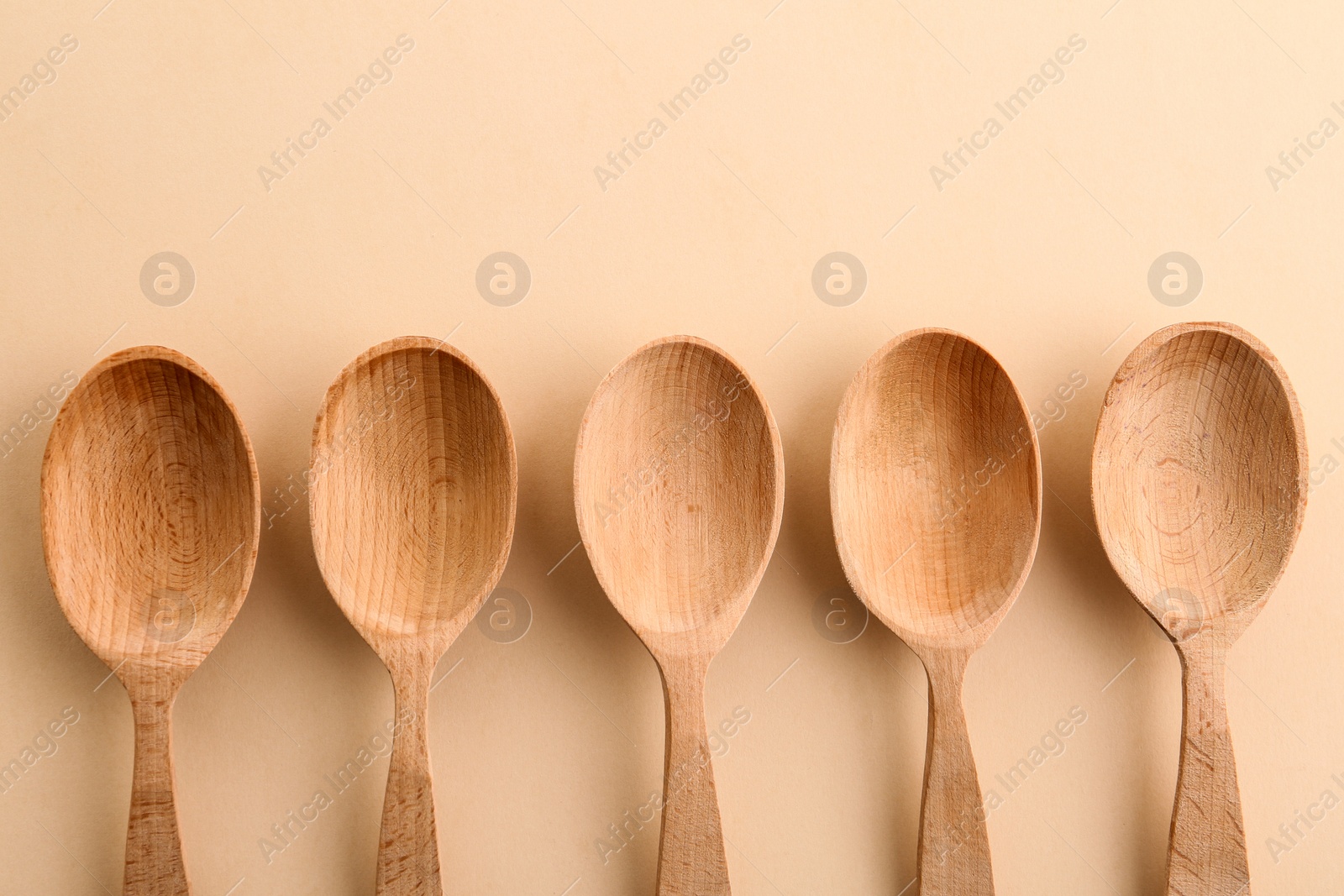 Photo of Flat lay composition with clean wooden spoons on color background