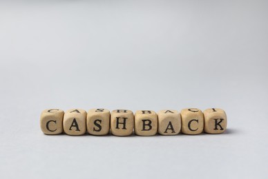 Photo of Word Cashback made with wooden cubes on grey background