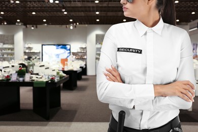 Female security guard wearing uniform in shopping mall