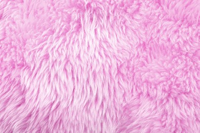 Texture of pink faux fur as background, closeup