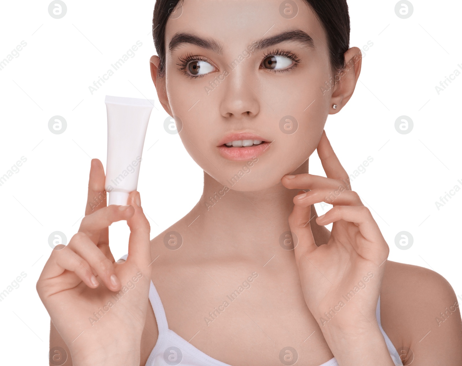 Photo of Teenage girl holding tube of foundation on white background