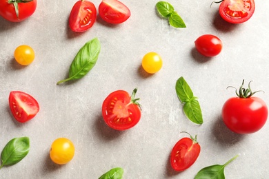 Photo of Flat lay composition with cherry tomatoes on light background