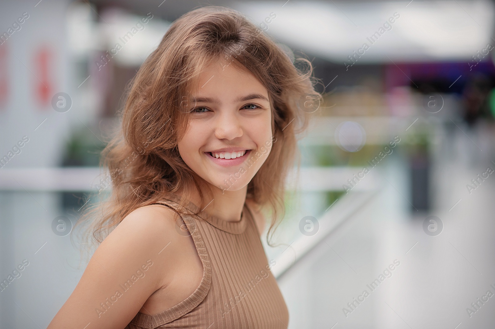 Photo of Portrait of beautiful teenage girl in shopping mall. Space for text