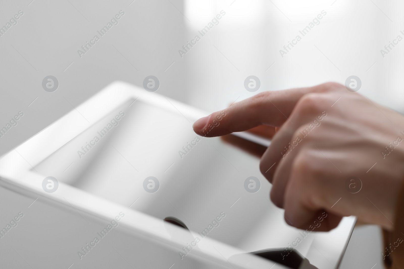 Photo of Closeup view of woman using modern tablet on blurred background