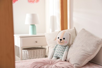 Toy dog on bed in child's room